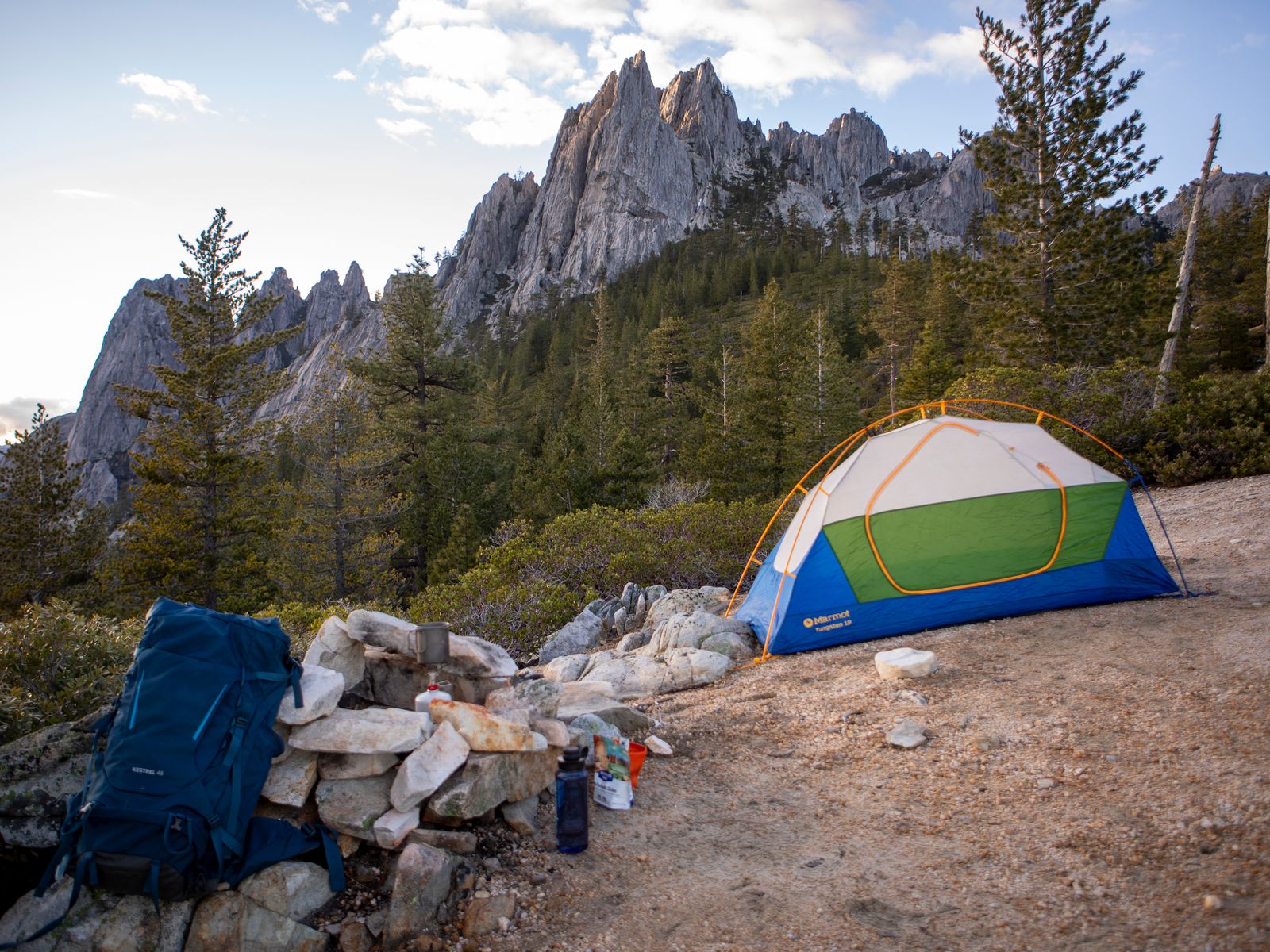 A backcountry tent camp set beneath rugged peaks